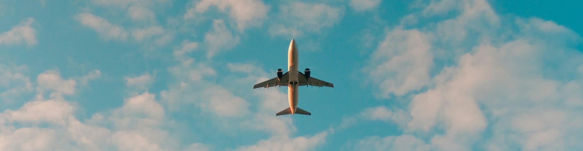 white airplane flying in the sky during daytime